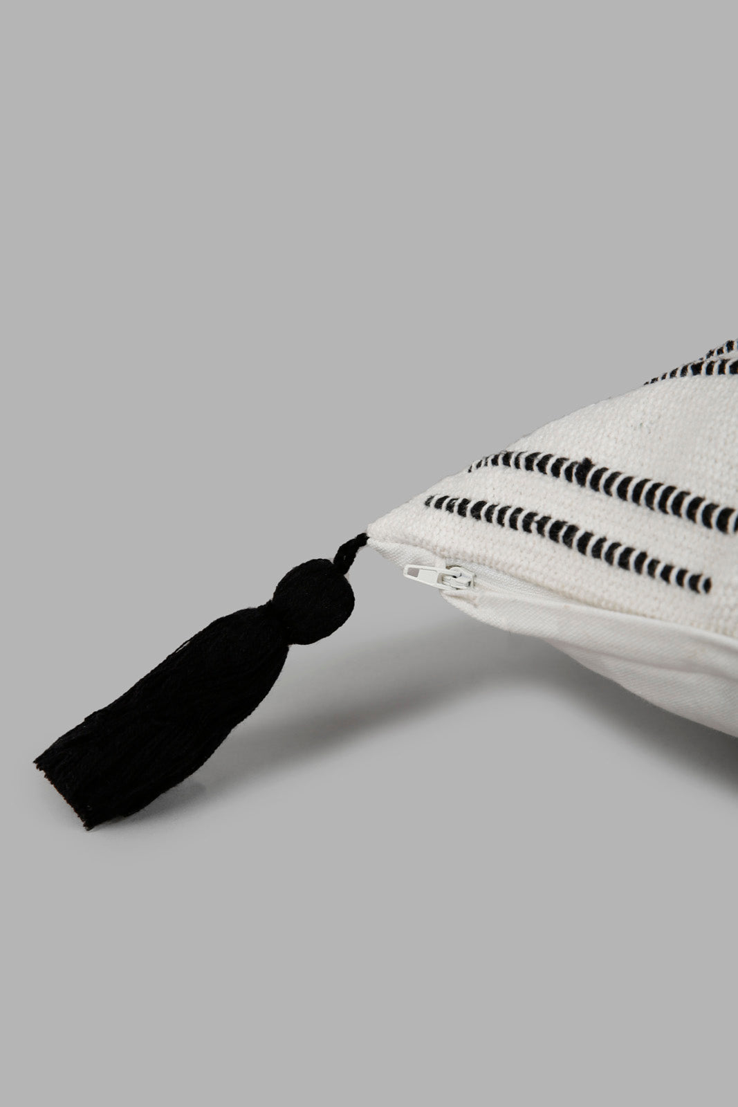 Redtag-White-And-Black-Handwoven-Cushion-With-Tassel-Category:Cushions,-Colour:White,-Deals:New-In,-Elsa,-Filter:Home-Bedroom,-HMW-BED-Cushions,-New-In-HMW-BED,-Non-Sale,-Section:Homewares,-W22O-Home-Bedroom-