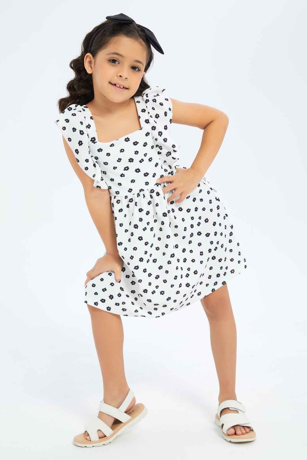 Redtag-Girls-Ruffle-Textured-Knit-Dress-White-Base-Black-Floral-Category:Dresses,-Colour:White,-Deals:New-In,-Dept:Girls,-Filter:Girls-(2-to-8-Yrs),-GIR-Dresses,-New-In-GIR-APL,-Non-Sale,-S23B,-Section:Girls-(0-to-14Yrs)-Girls-2 to 8 Years