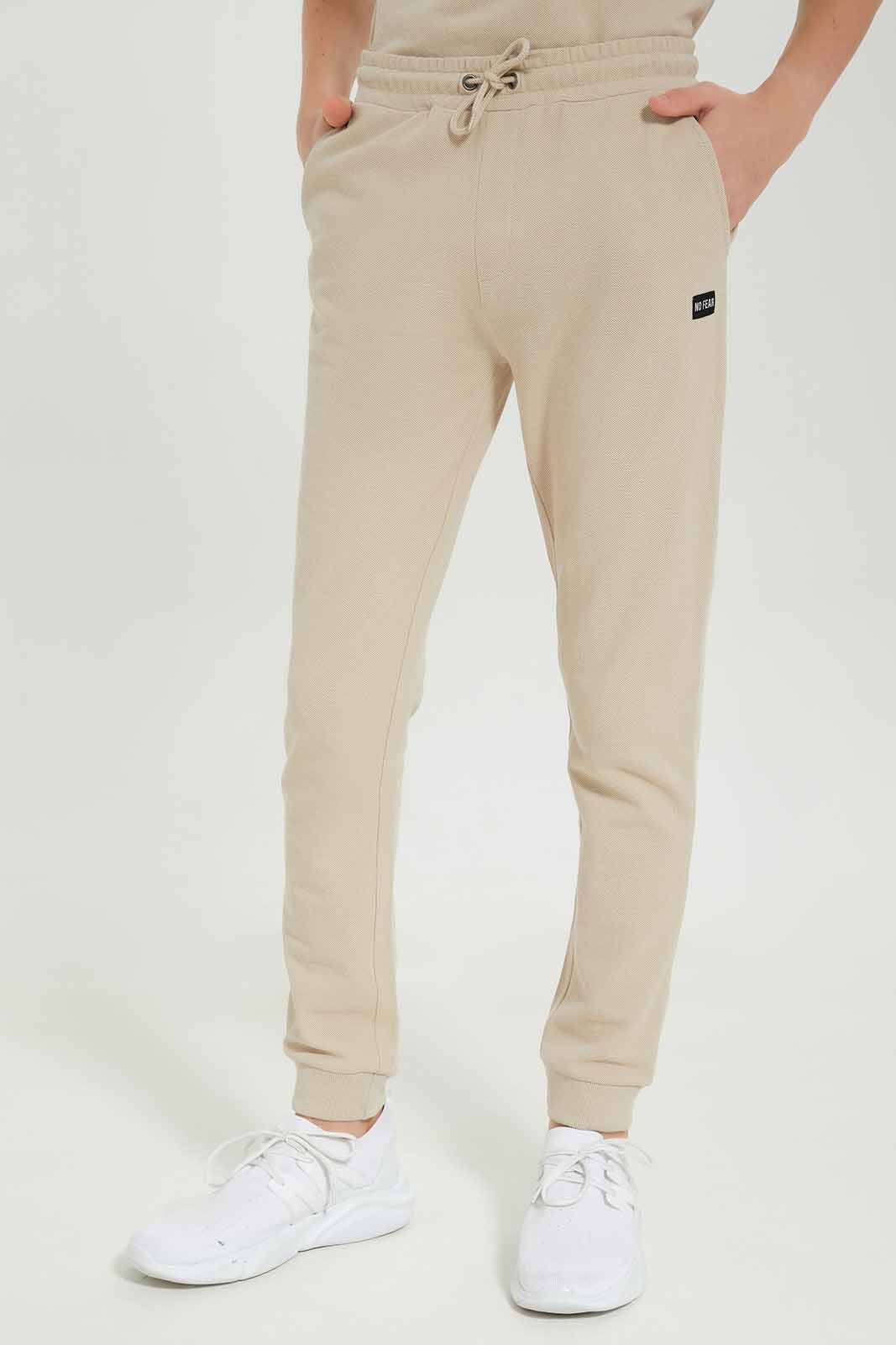 Redtag-Boys-Beige-Pique-Active-Pants-BSR-Joggers,-Category:Joggers,-Colour:Beige,-Deals:New-In,-Dept:Boys,-Filter:Senior-Boys-(8-to-14-Yrs),-New-In-BSR-APL,-Non-Sale,-S23A,-Section:Boys-(0-to-14Yrs),-TBL-Senior-Boys-9 to 14 Years