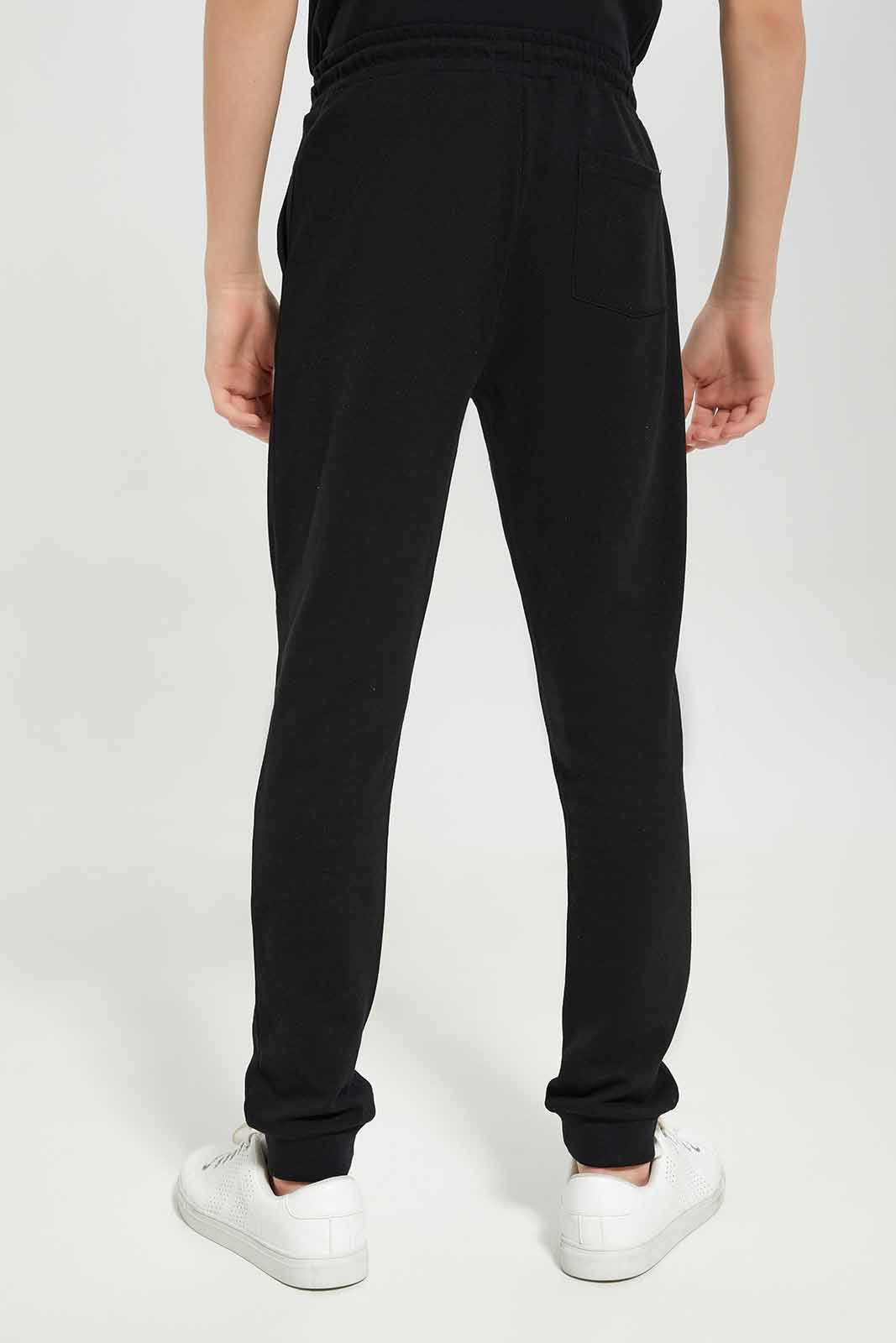 Redtag-Boys-Black-Pique-Active-Pants-BSR-Joggers,-Category:Joggers,-Colour:Black,-Deals:New-In,-Dept:Boys,-Filter:Senior-Boys-(8-to-14-Yrs),-New-In-BSR-APL,-Non-Sale,-S23A,-Section:Boys-(0-to-14Yrs),-TBL-Senior-Boys-9 to 14 Years