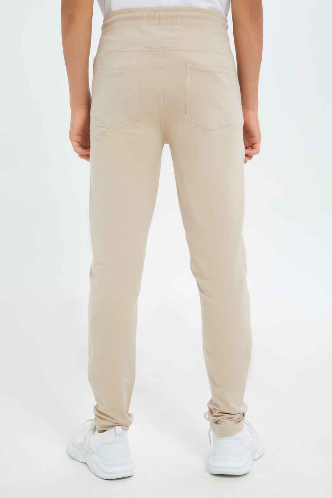 Redtag-Boys-Beige-Stretch-Active-Pants-BSR-Joggers,-Category:Joggers,-Colour:Beige,-Deals:New-In,-Dept:Boys,-Filter:Senior-Boys-(8-to-14-Yrs),-New-In-BSR-APL,-Non-Sale,-S23A,-Section:Boys-(0-to-14Yrs),-VLM-Senior-Boys-9 to 14 Years