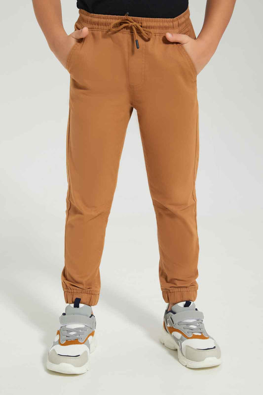 Redtag-Boys-Brown-Elasticated-Waist-Jogger-BOY-Trousers,-Category:Trousers,-Colour:Brown,-Deals:New-In,-Dept:Boys,-Filter:Boys-(2-to-8-Yrs),-New-In-BOY-APL,-Non-Sale,-S23A,-Section:Boys-(0-to-14Yrs),-VLM-Boys-2 to 8 Years