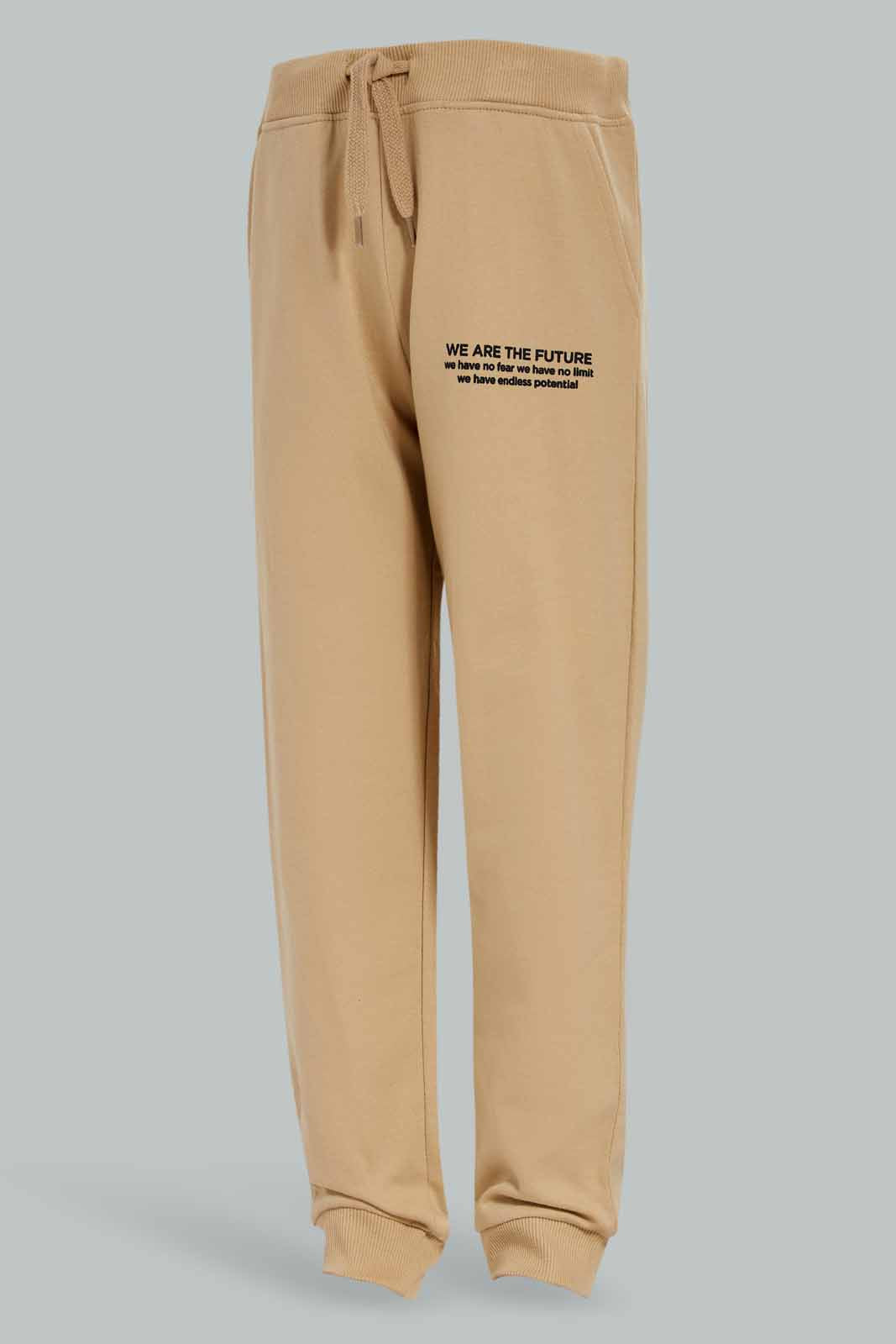 Redtag-Boys-Beige-Jogpant-With-Print-BOY-Joggers,-Category:Joggers,-Colour:Beige,-Deals:New-In,-Dept:Boys,-Filter:Boys-(2-to-8-Yrs),-New-In-BOY-APL,-Non-Sale,-S23A,-Section:Boys-(0-to-14Yrs),-TBL-Boys-2 to 8 Years