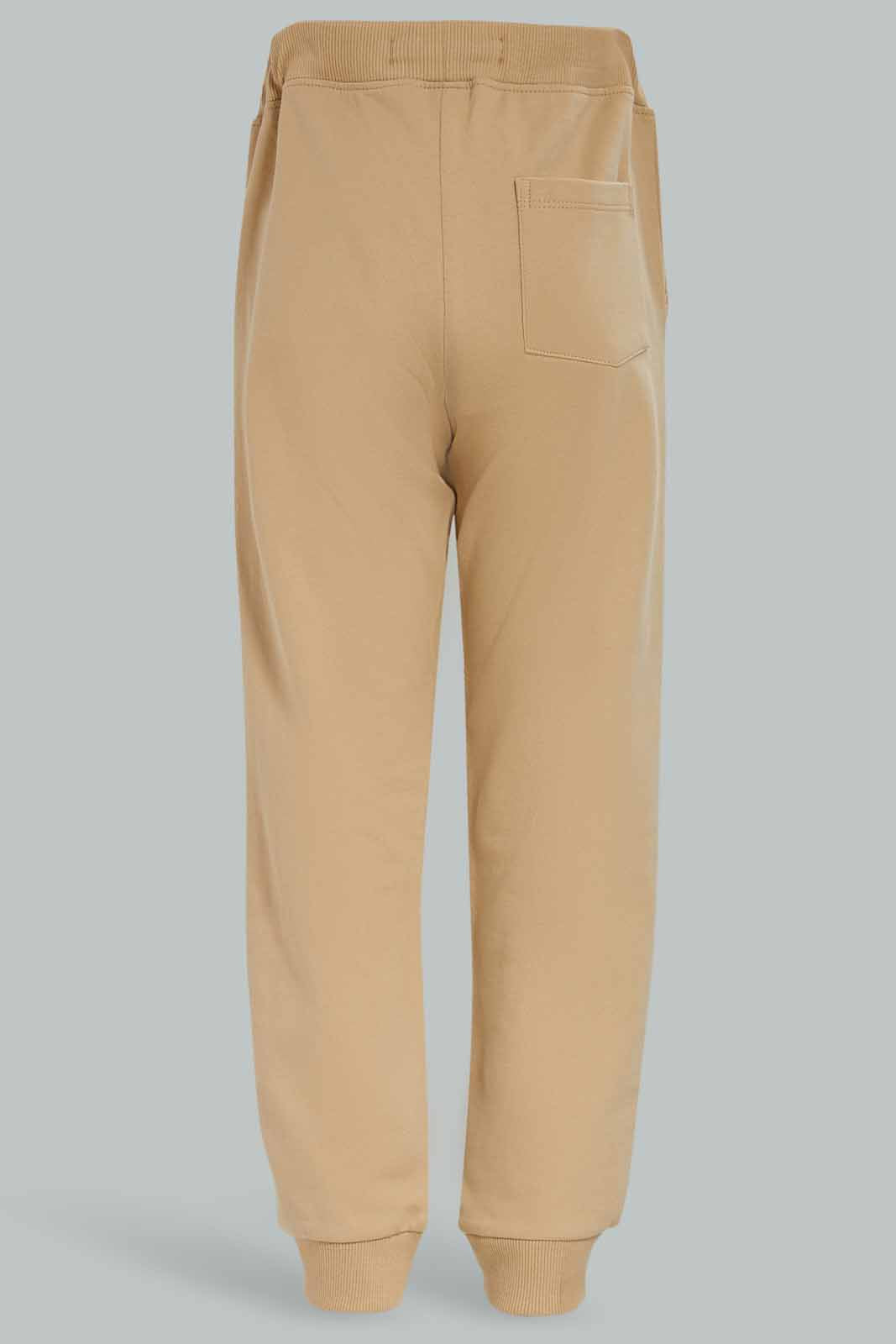 Redtag-Boys-Beige-Jogpant-With-Print-BOY-Joggers,-Category:Joggers,-Colour:Beige,-Deals:New-In,-Dept:Boys,-Filter:Boys-(2-to-8-Yrs),-New-In-BOY-APL,-Non-Sale,-S23A,-Section:Boys-(0-to-14Yrs),-TBL-Boys-2 to 8 Years