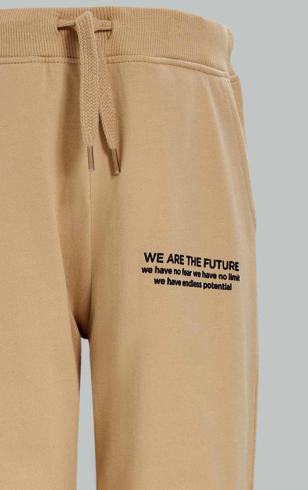 Redtag-Boys-Beige-Jogpant-With-Print-BOY-Joggers,-Category:Joggers,-Colour:Beige,-Deals:New-In,-Dept:Boys,-Filter:Boys-(2-to-8-Yrs),-New-In-BOY-APL,-Non-Sale,-S23A,-Section:Boys-(0-to-14Yrs),-TBL-Boys-2 to 8 Years