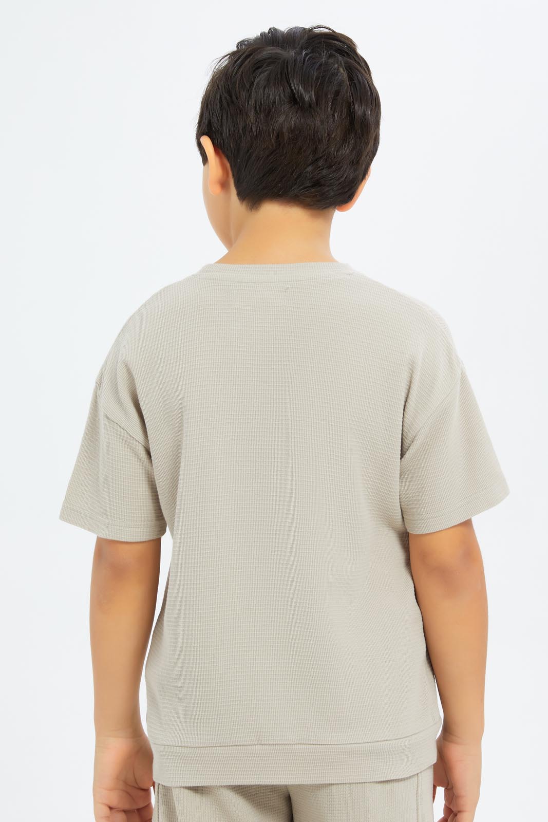 Redtag-Boys-Beige-Over-Size-Waffle-T-Shirt-BOY-T-Shirts,-Category:T-Shirts,-CHA,-Colour:Beige,-Deals:New-In,-Dept:Boys,-Filter:Boys-(2-to-8-Yrs),-New-In-BOY-APL,-Non-Sale,-S23C,-Section:Boys-(0-to-14Yrs)-Boys-2 to 8 Years