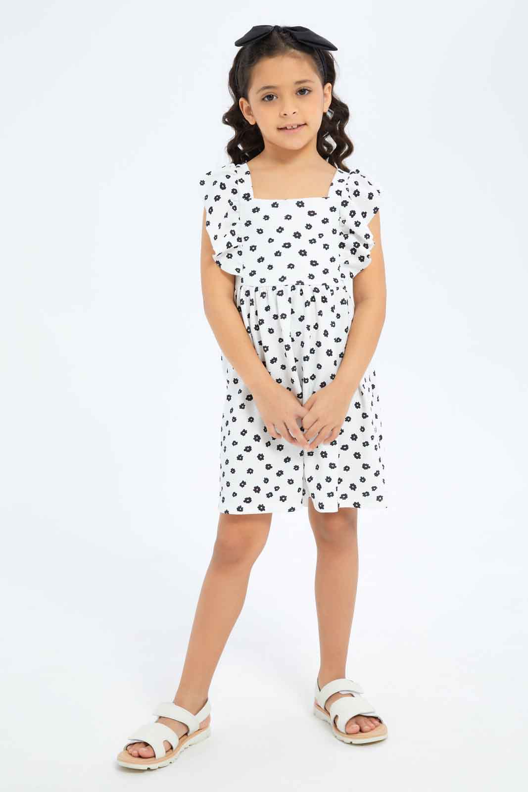 Redtag-Girls-Ruffle-Textured-Knit-Dress-White-Base-Black-Floral-Category:Dresses,-Colour:White,-Deals:New-In,-Dept:Girls,-Filter:Girls-(2-to-8-Yrs),-GIR-Dresses,-New-In-GIR-APL,-Non-Sale,-S23B,-Section:Girls-(0-to-14Yrs)-Girls-2 to 8 Years