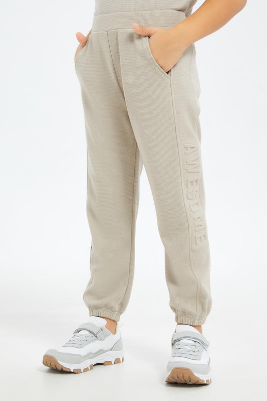 Redtag-Boys-Beige-Pique-Jaquard-Embosed-Track-Pant-BOY-Joggers,-Category:Joggers,-Colour:Beige,-Deals:New-In,-Dept:Boys,-Filter:Boys-(2-to-8-Yrs),-New-In-BOY-APL,-Non-Sale,-S23C,-Section:Boys-(0-to-14Yrs)-Boys-2 to 8 Years