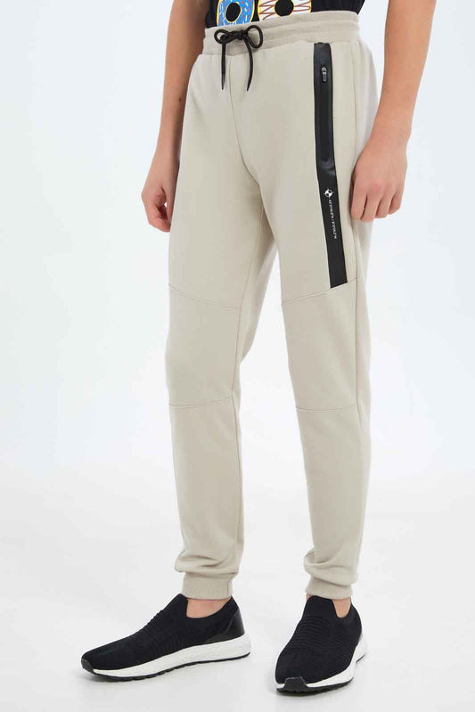 Redtag-Boys-Beige-Heat-Seal-Zip-Active-Pants-BSR-Joggers,-Category:Joggers,-Colour:Beige,-Deals:New-In,-Dept:Boys,-Filter:Senior-Boys-(8-to-14-Yrs),-New-In-BSR-APL,-Non-Sale,-S23C,-Section:Boys-(0-to-14Yrs)-Senior-Boys-9 to 14 Years