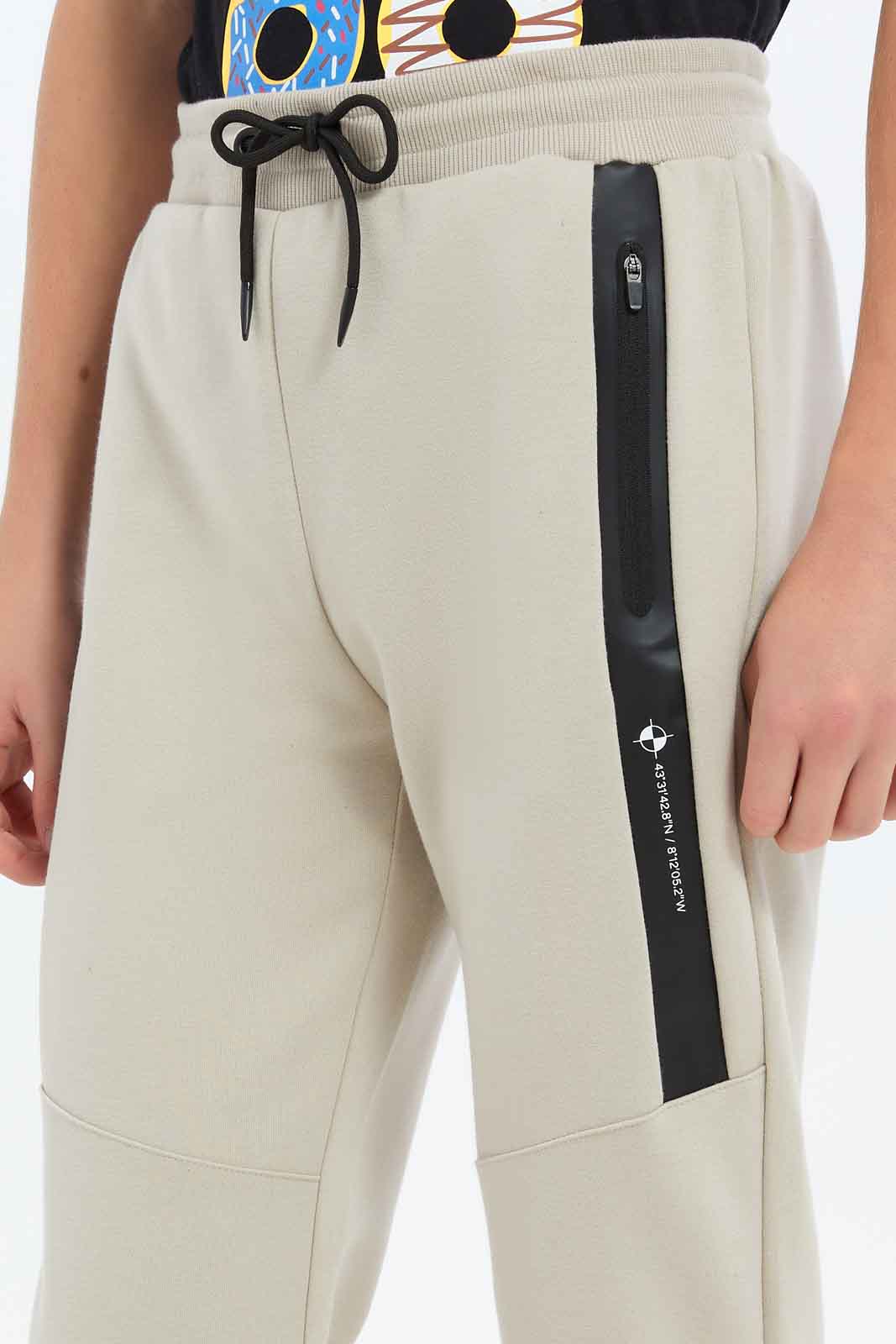 Redtag-Boys-Beige-Heat-Seal-Zip-Active-Pants-BSR-Joggers,-Category:Joggers,-Colour:Beige,-Deals:New-In,-Dept:Boys,-Filter:Senior-Boys-(8-to-14-Yrs),-New-In-BSR-APL,-Non-Sale,-S23C,-Section:Boys-(0-to-14Yrs)-Senior-Boys-9 to 14 Years