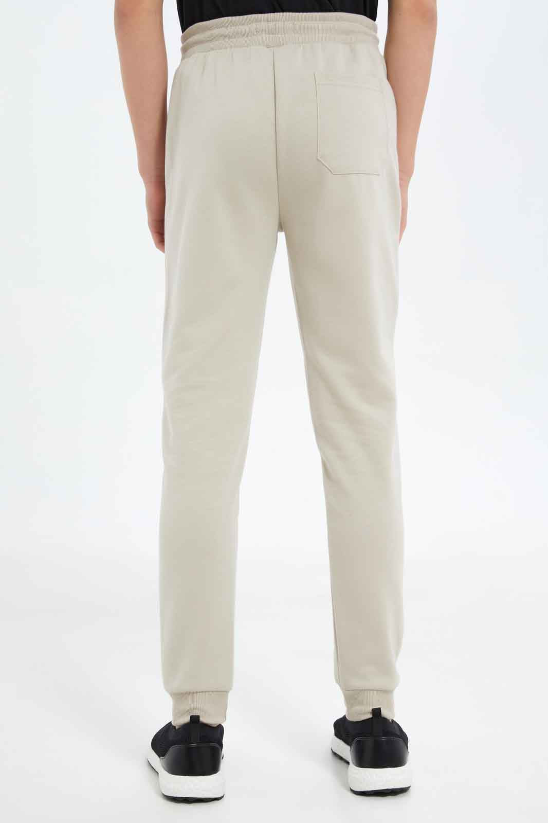 Redtag-Boys-Beige-Heat-Seal-Zip-Active-Pants-BSR-Joggers,-Category:Joggers,-Colour:Beige,-Deals:New-In,-Dept:Boys,-Filter:Senior-Boys-(8-to-14-Yrs),-New-In-BSR-APL,-Non-Sale,-S23C,-Section:Boys-(0-to-14Yrs)-Senior-Boys-9 to 14 Years