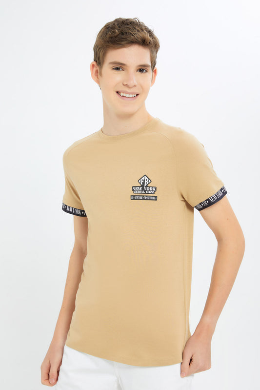 Redtag-Boys-Beige-Tape-On-Sleeve-Cuff-Tee-BSR-T-Shirts,-Category:T-Shirts,-Colour:Beige,-Deals:New-In,-Dept:Boys,-Filter:Senior-Boys-(8-to-14-Yrs),-H1:KWR,-H2:BSR,-H3:TSH,-H4:TSH,-New-In-BSR-APL,-Non-Sale,-S23C,-Season:S23C,-Section:Boys-(0-to-14Yrs)-Senior-Boys-9 to 14 Years