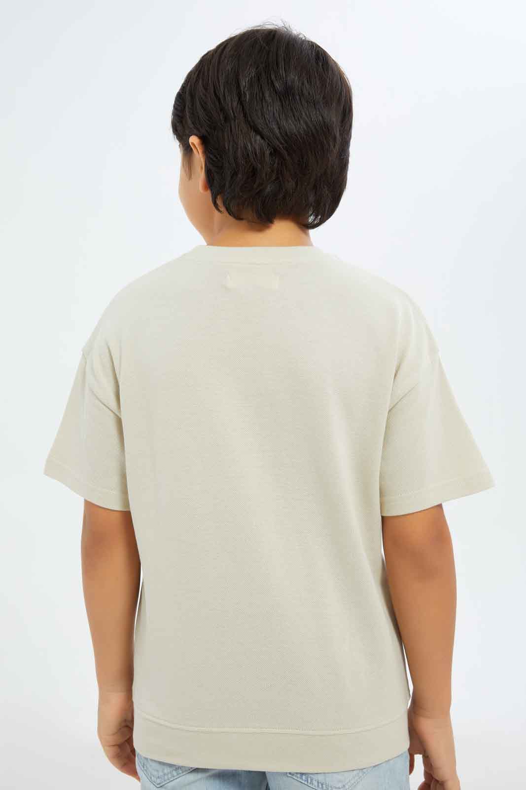 Redtag-Boys-Beige-Embroidered-Short-Sleeve-Oversize-Pique-T-Shirt-BOY-T-Shirts,-Category:T-Shirts,-Colour:Beige,-Deals:New-In,-Filter:Boys-(2-to-8-Yrs),-New-In-BOY-APL,-Non-Sale,-S23C,-Section:Boys-(0-to-14Yrs),-TBL-Boys-2 to 8 Years