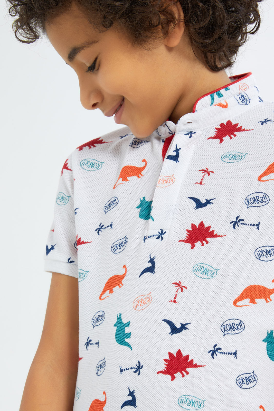 Redtag-Boys-White-Dino-Allover-Print-Stand-Up-Collar-Polo-Shirt-BOY-Polo-T-Shirts,-Category:Polo-T-Shirts,-Colour:White,-Deals:New-In,-Filter:Boys-(2-to-8-Yrs),-New-In-BOY-APL,-Non-Sale,-S23C,-Section:Boys-(0-to-14Yrs),-TBL-Boys-2 to 8 Years
